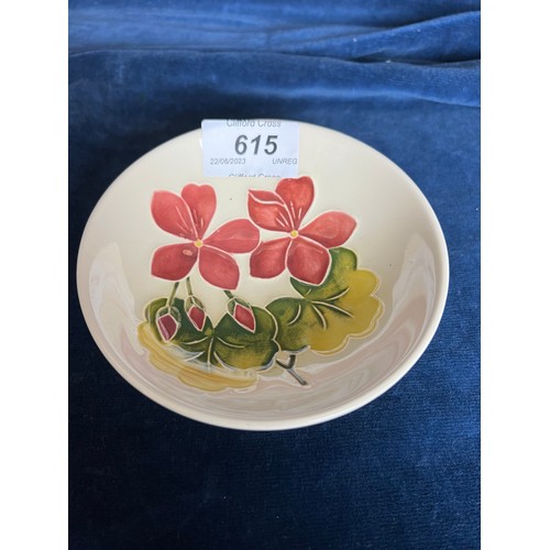 615 - A Moorcroft small open dish having cream ground and spring flower design.