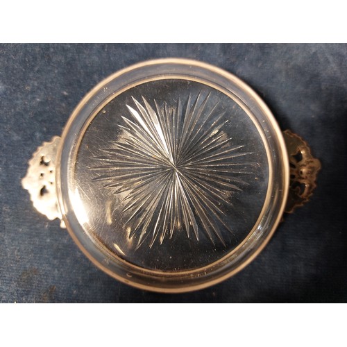 176 - A cut glass and silver wine taster/Quaich glass having starburst centre design, silver mount, hallma... 