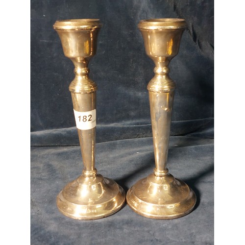 182 - A pair of silver candlesticks of plain design, both hallmarked, maker's mark A.T.C.