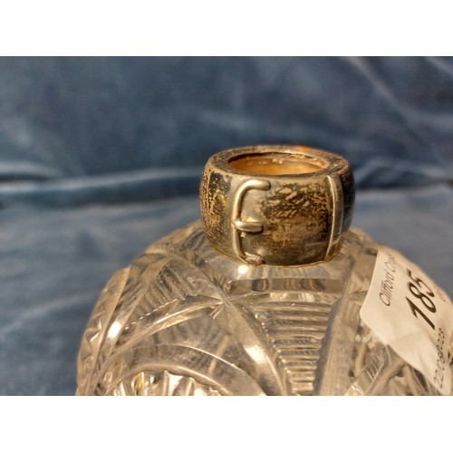 185 - A cut glass scent bottle with silver mount - marks worn.