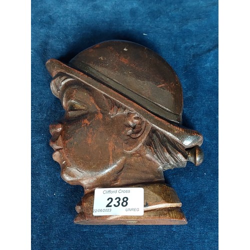 238 - A carved wooden cigarette dispenser in the shape of a boy's head.