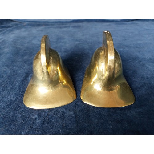 260 - Two small brass decorative firefighters helmets, each inset with a metal button.