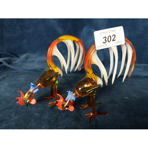 302 - A pair of coloured hand-blown glass figures of chickens, together with a hand-blown glass tree with ... 