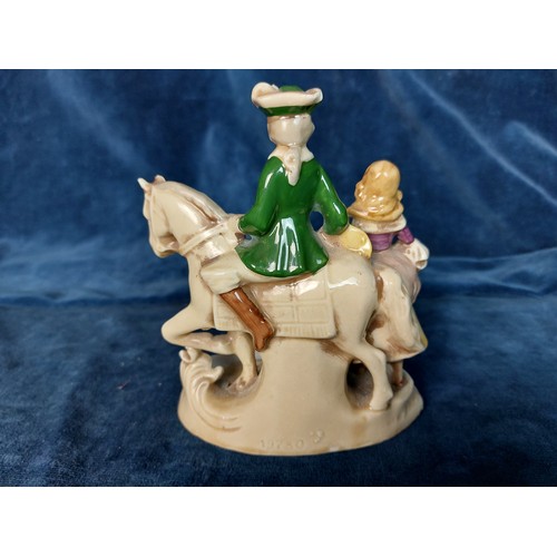 303 - A figure of a Man on a Horse with Lady, marked 'Foreign'.