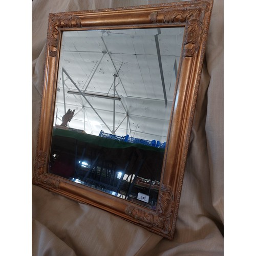 347 - A large gilt framed wall mirror having beveled edges to the glass. 62.5cm wide x 72.5cm tall.