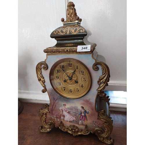 348 - An antique French porcelain clock, having green ground and gilt highlights and ormolu mounts, with a... 