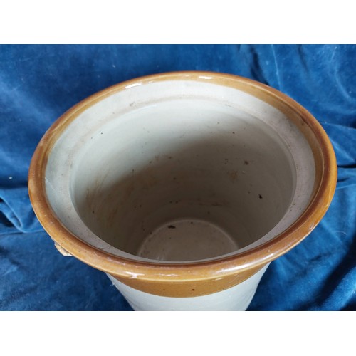 367 - A 2-tone stoneware pot having 2 applied handles and a hand-made wooden lid.