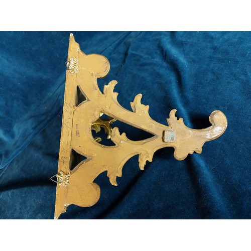 381 - A rococo style carved gold coloured wall bracket shelf.