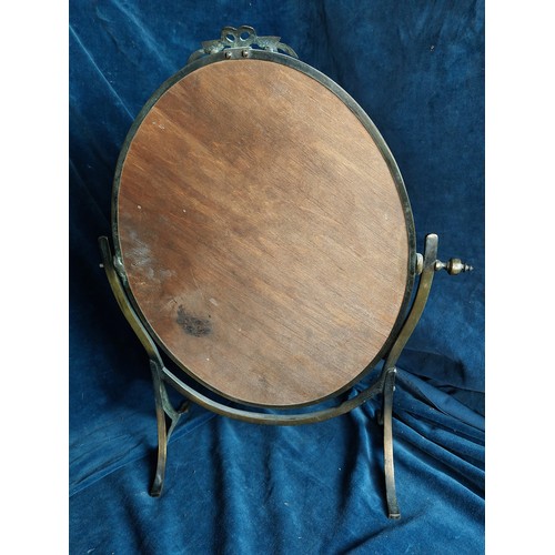 382 - A brass effect oval swing dressing table mirror, having bevel edge.