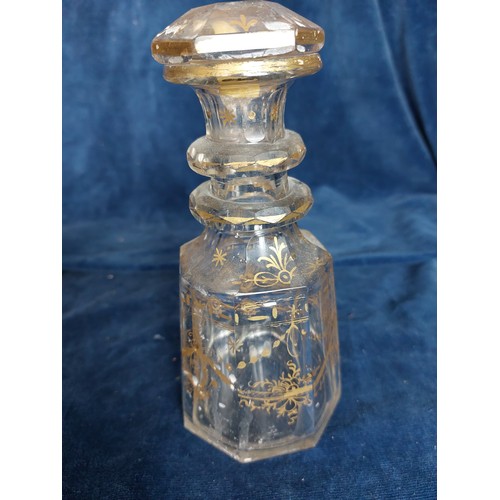 383 - A small cut glass decanter with stopper, having gilt highlights A/F, together with an enamelled Jubi... 