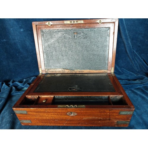 396 - An antique mahogany writing slope, having brass bound edges and corners, and oval plaque inset, in n... 