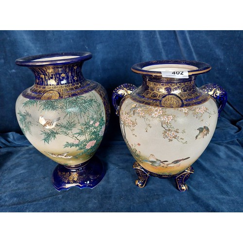 402 - Two decorative Oriental vases, both with blue ground and bird decoration, with gold coloured highlig... 