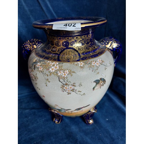 402 - Two decorative Oriental vases, both with blue ground and bird decoration, with gold coloured highlig... 