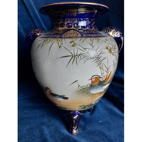 402 - Two decorative Oriental vases, both with blue ground and bird decoration, with gold coloured highlig... 