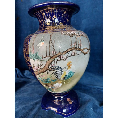 402 - Two decorative Oriental vases, both with blue ground and bird decoration, with gold coloured highlig... 