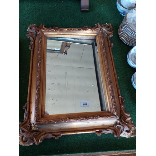 404 - An antique carved gilt frame mirror.