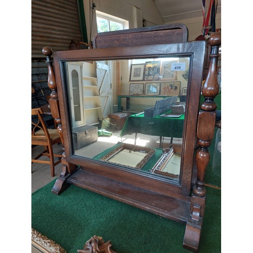 406 - An oak swing dressing table mirror with shelf under.