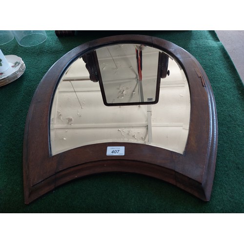 407 - An antique oak framed horseshoe bevelled edge mirror.