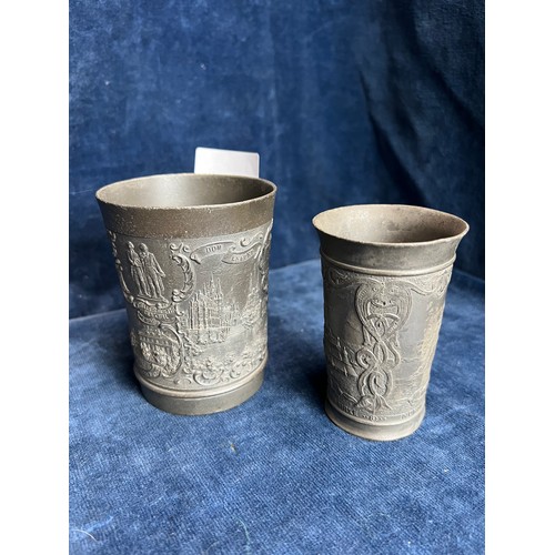 560 - Two metal European beakers bearing designs of Norway and Germany.