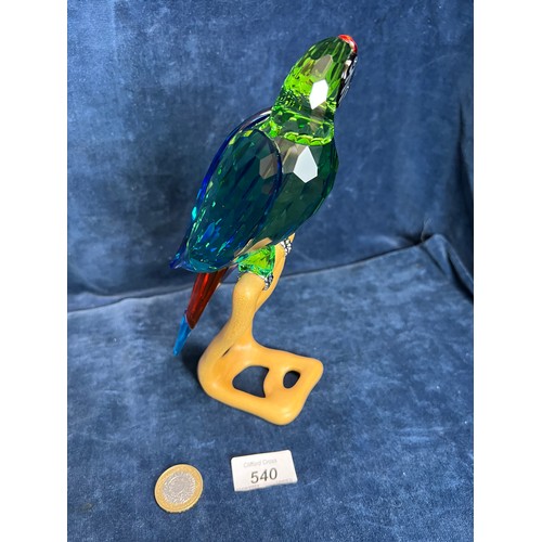 540 - A Swarovski Crystal figure of a Macaw on wooden stand.