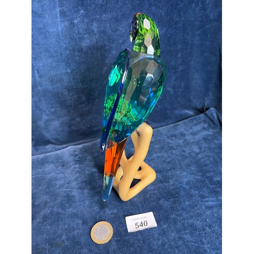 540 - A Swarovski Crystal figure of a Macaw on wooden stand.