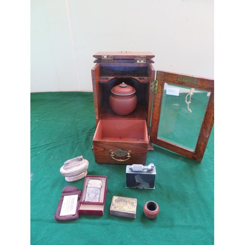 427 - An oak smoker's cabinet with bevelled glass front with mixing jar and 2 Ronson lighters, and Mcmurdo... 