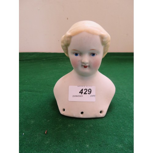 429 - A porcelain doll's head with hand-painted features.