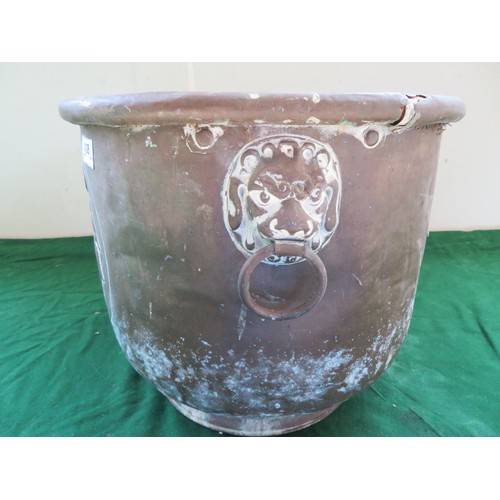 438 - A copper coal scuttle with 2-drop handles mounted with lions and heraldic coat of arms design.