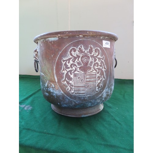 438 - A copper coal scuttle with 2-drop handles mounted with lions and heraldic coat of arms design.