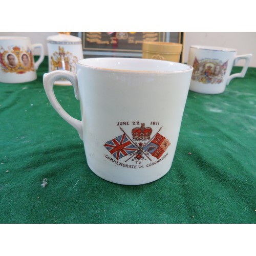 447 - A framed Regimental Coat of Arms and 5 pieces of commemorative ware being 3 mugs, 1 beaker and a bel... 