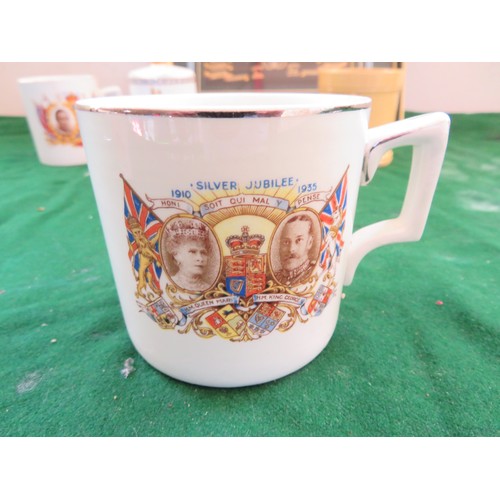 447 - A framed Regimental Coat of Arms and 5 pieces of commemorative ware being 3 mugs, 1 beaker and a bel... 