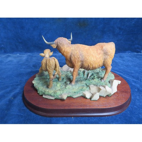 461 - An Aynsley Mastercraft hand-painted figure of a Aberdeen Angus cow and calf on wooden base.