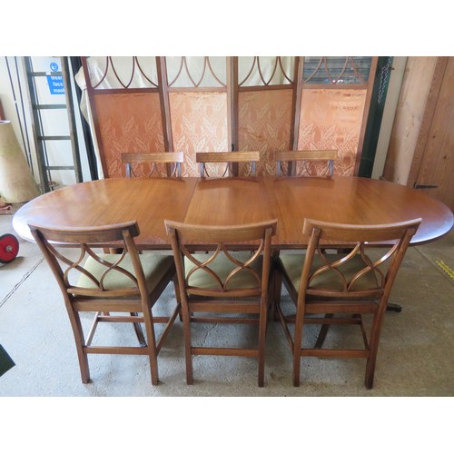 772 - An extending mahogany dining table and 6 chairs.  The table is on 2-pedestal bases with splayed legs... 