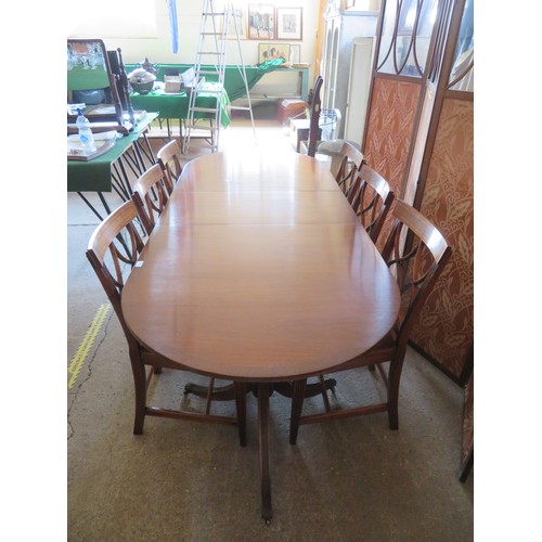 772 - An extending mahogany dining table and 6 chairs.  The table is on 2-pedestal bases with splayed legs... 