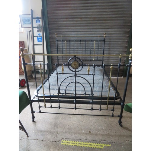 771 - An antique 5ft bedstead, painted black with ornate brass fittings.