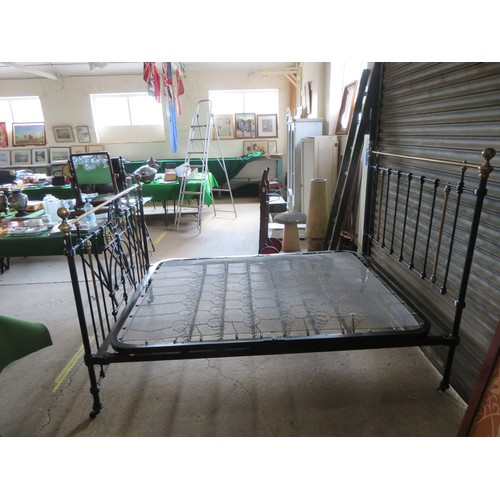 771 - An antique 5ft bedstead, painted black with ornate brass fittings.