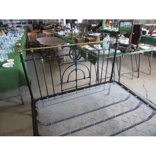 771 - An antique 5ft bedstead, painted black with ornate brass fittings.