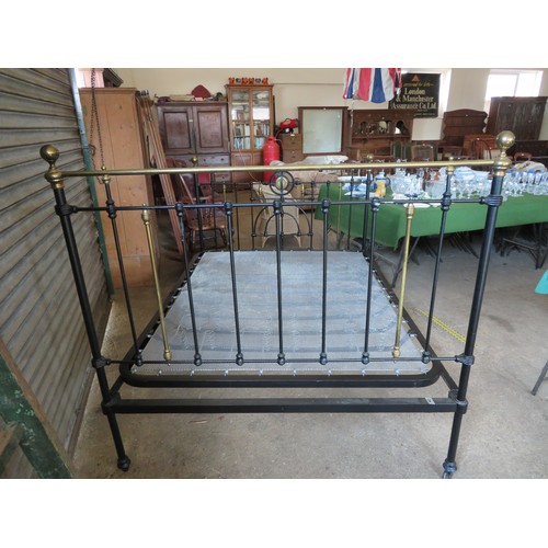 771 - An antique 5ft bedstead, painted black with ornate brass fittings.