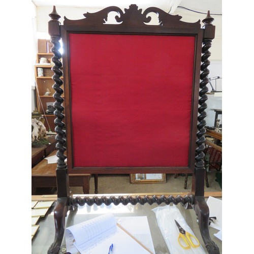 353 - A large antique mahogany framed fire screen with barley twist supports and carved foliate pediment w... 