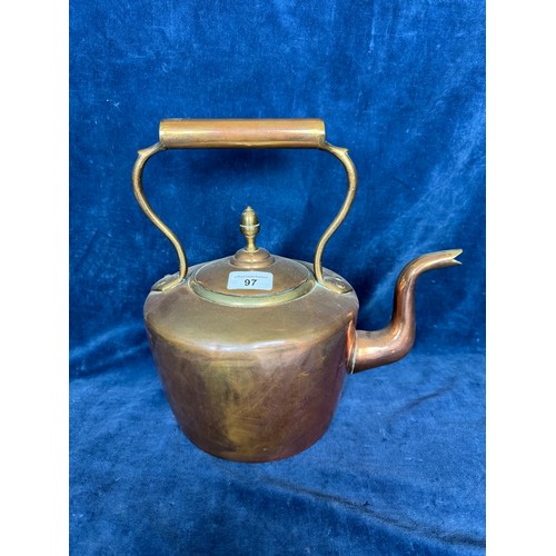 97 - A copper and brass kettle having acorn finial, marked to base 
