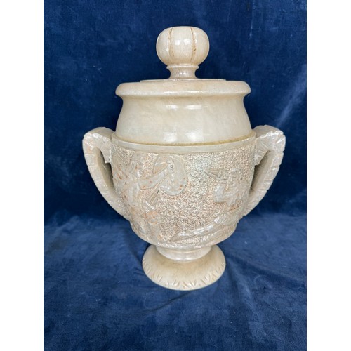 105 - An Alabaster decorative lidded urn with stylised handles and Egyptian figures.