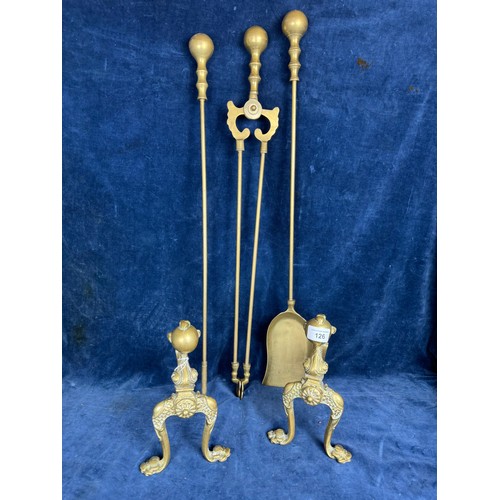 126 - A brass companion set comprising poker, shovel, tongs and firedogs having ball and claw design