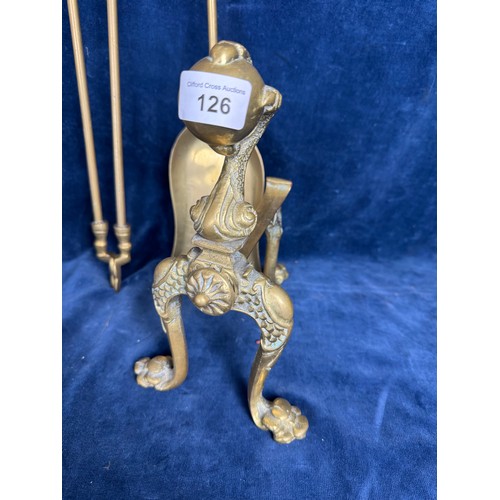 126 - A brass companion set comprising poker, shovel, tongs and firedogs having ball and claw design