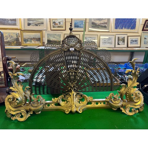 132 - An antique French brass Rococo style fire fender with ornate acanthus leaf decoration and adjustable... 