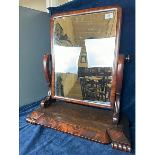 135 - An antique mahogany swing dressing table mirror with carved supports on scroll feet.