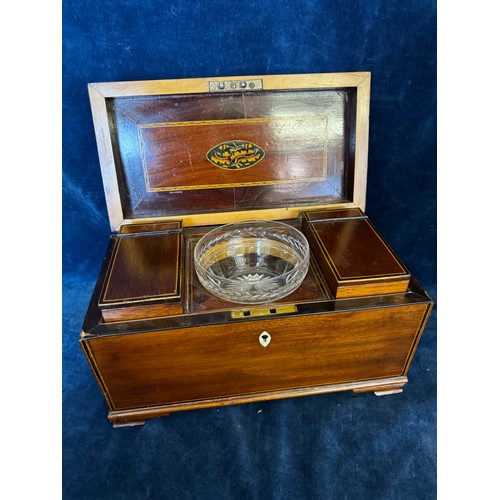 137 - An antique mahogany tea caddy with inlaid decoration having a cut glass mixing bowl, 2 removable hin... 
