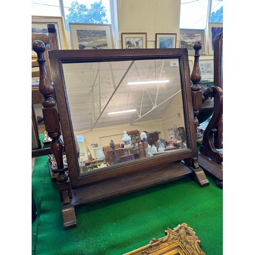 139 - An oak swing dressing table mirror with shelf under.