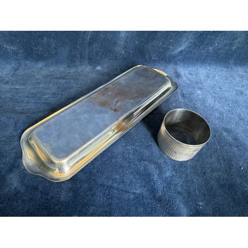 140 - A small silver rectangular tray of plain design hallmarked Birmingham together with a silver napkin ... 