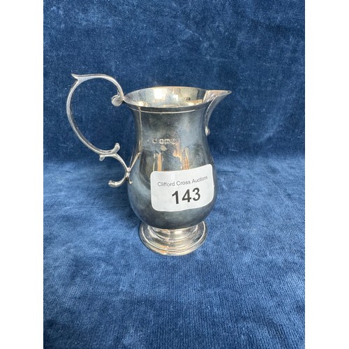 143 - A small silver jug of plain design with scroll applied handle, hallmarked Sheffield