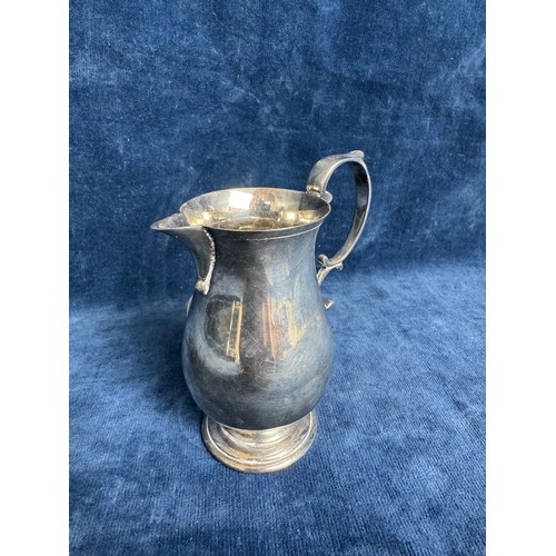 143 - A small silver jug of plain design with scroll applied handle, hallmarked Sheffield